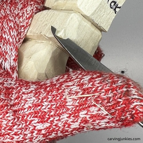 Shaving back on carved old man