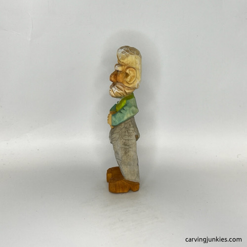 Left side of painted carved old man