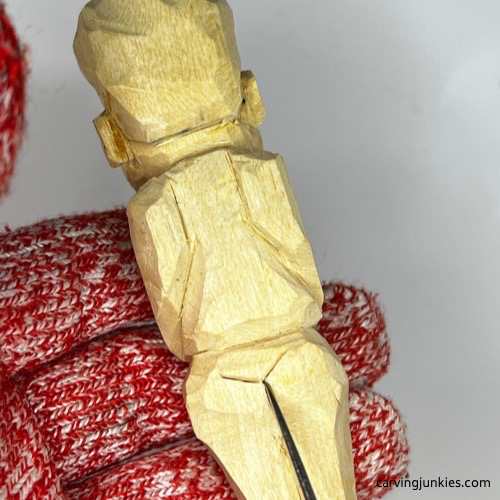 Refining back side of tubby man wood carving Carving back side of tubby man wood carving