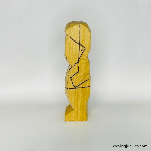 Left details drawn on tubby man wood carving Left details on tubby man wood carving