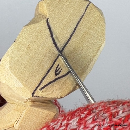 Stop cut to shape ear on tubby man wood carving Starting ear on tubby man wood carving