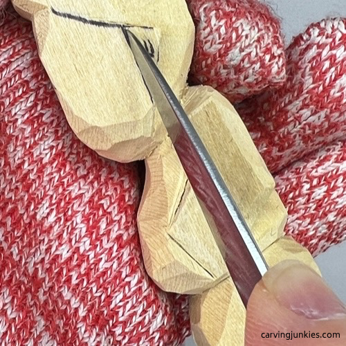 Cutting side ear on tubby man wood carving Stop cut to separate ear on tubby man wood carving