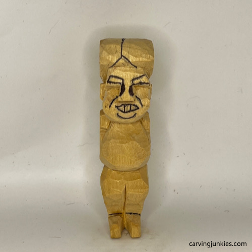Drawn face details on tubby man wood carving Adding face details on tubby man wood carving