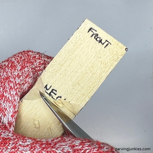 Cutting head on tubby man wood carving Separating head on tubby man wood carving