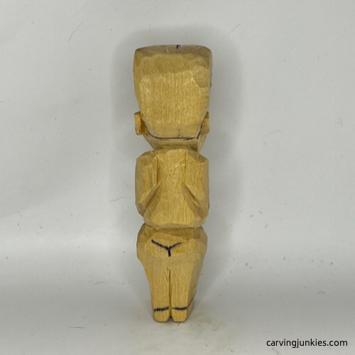 Drawn back hairline on tubby man wood carving Back hairline on tubby man wood carving