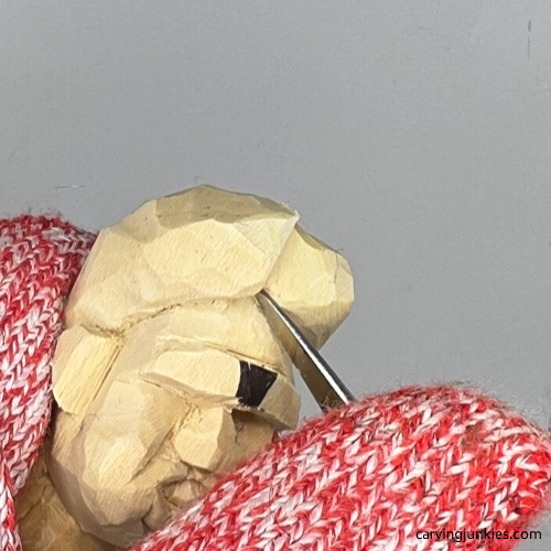 Carving part in hair on tubby man wood carving Cutting part in hair on tubby man wood carving