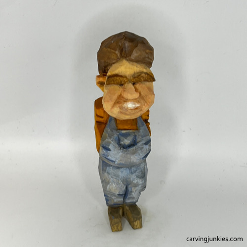 Front view of painted tubby man wood carving Front of painted tubby man wood carving