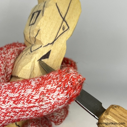 Starting pyramid cut on tubby man wood carving Making pyramid cut on tubby man wood carving