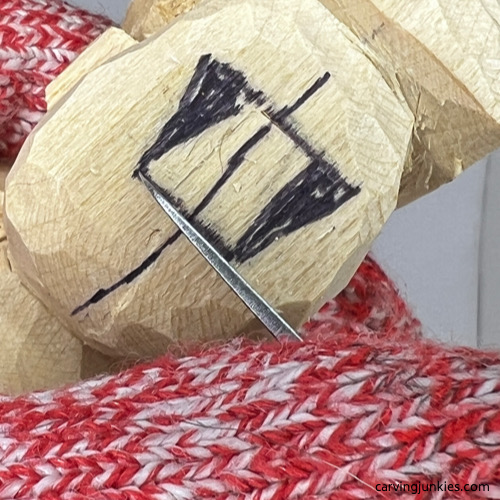 Starting nose on tubby man wood carving Making stop cut under nose on tubby man wood carving