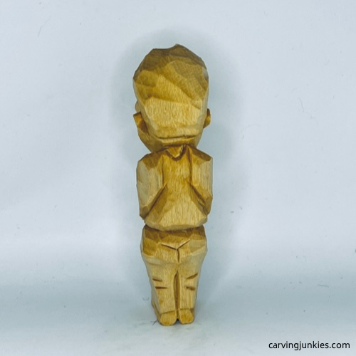 Back side of unpainted tubby man wood carving Back view of unpainted tubby man wood carving