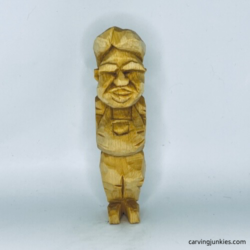 Front side of unpainted tubby man wood carving Front view of unpainted tubby man wood carving