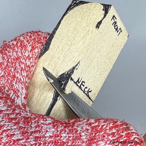 Starting a V cut on tubby man wood carving Making a V cut on tubby man wood carving