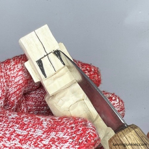 Making pyramid cut on carved old man