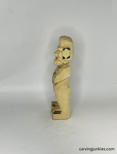 Ears are marked for shaping on carved old man