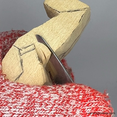 Making stop cut on little man caricature carving