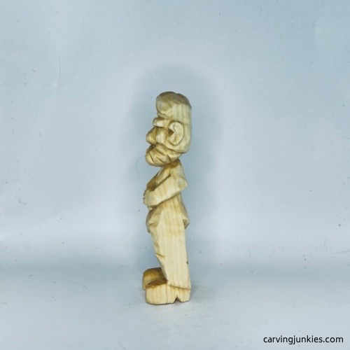 Left view of unpainted carved old man