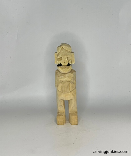 Drawing smile lines on carved old man