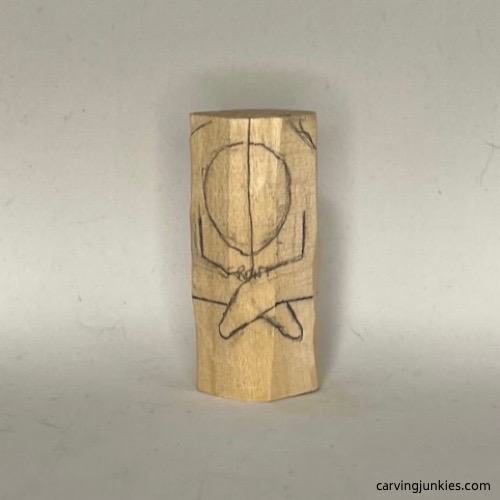 Front details are sketched on wood carved mermaid body