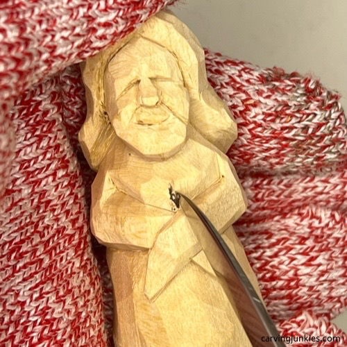 Carving the breast on the wood carved mermaid