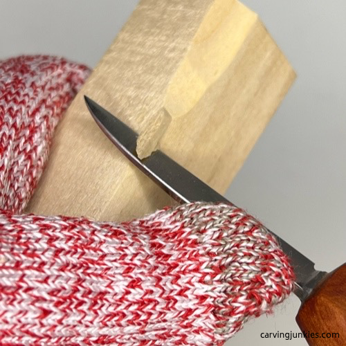 Carving off corner of wood carved mermaid