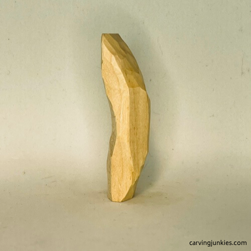 Curving tail on wood carved mermaid