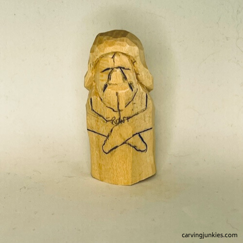 Facial details sketched on wood carved mermaid