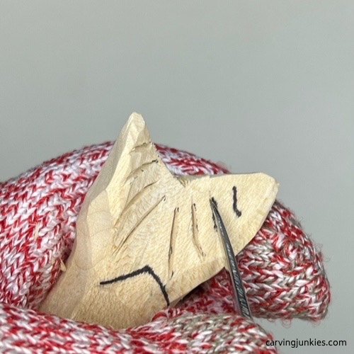 Carving fluke lines on wood carved mermaid