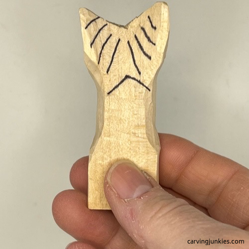 Fluke lines sketched on wood carved mermaid