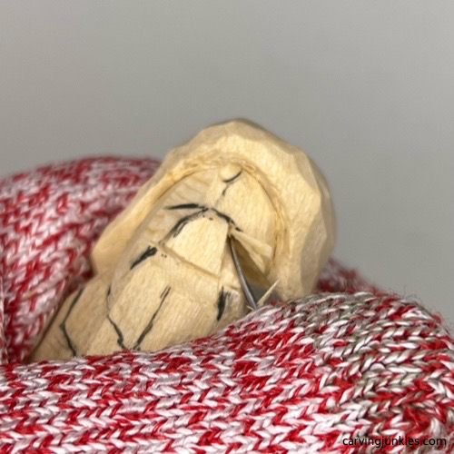 Mouth is sketched on wood carved mermaid