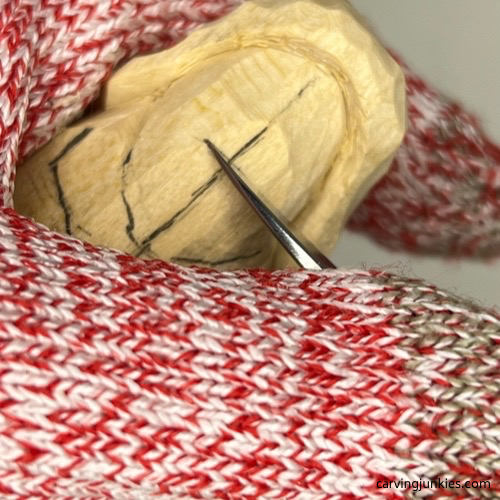 Making stop cut under nose of wood carved mermaid