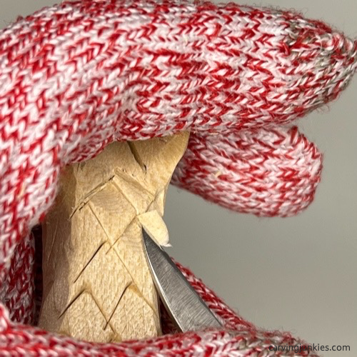 Narrowing scales on wood carved mermaid