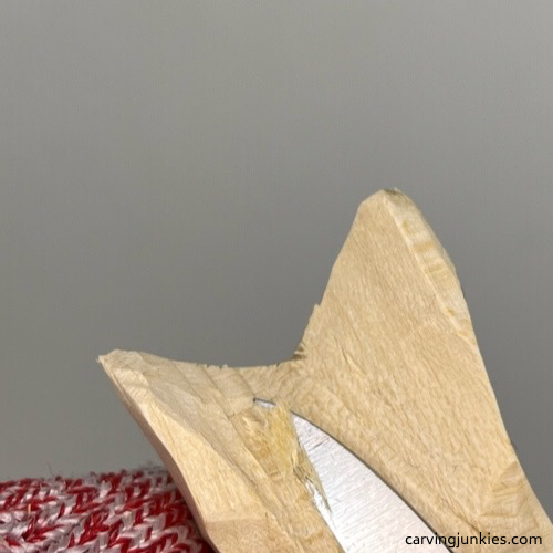 Scooping wood to curve tail on wood carved mermaid