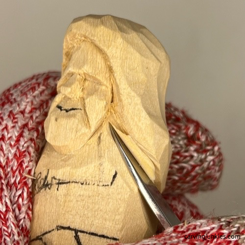 Shaping shoulders on wood carved mermaid