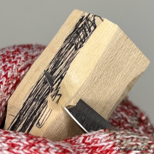 Narrowing sides of tail on wood carved mermaid