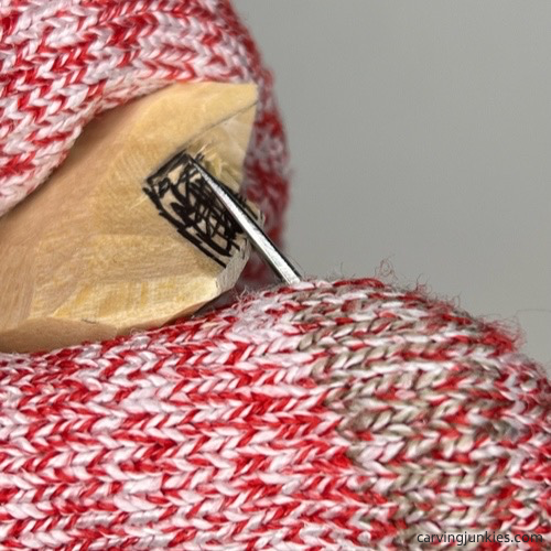 Making a stop cut to split the tail on wood carved mermaid