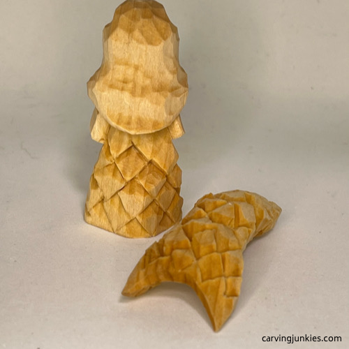 Back view of unpainted wood carved mermaid