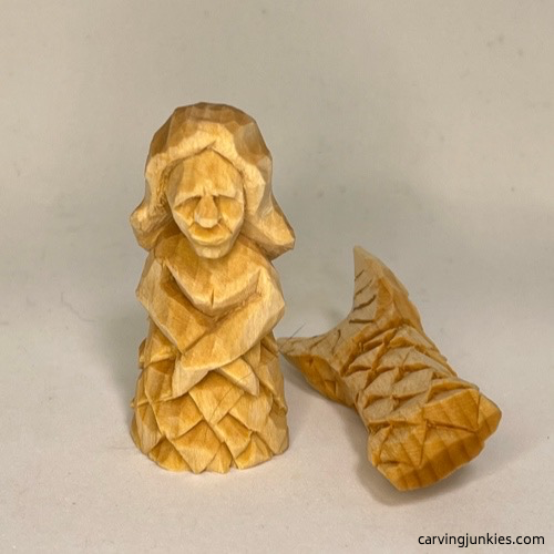 Front view of unpainted wood carved mermaid