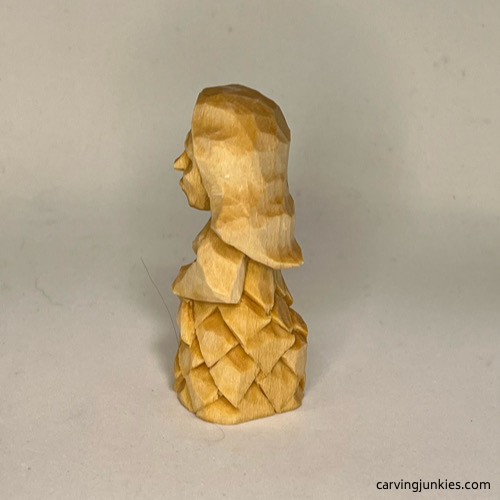 Left view of unpainted wood carved mermaid