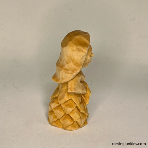 RIght view of unpainted wood carved mermaid