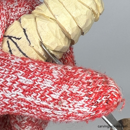 Cutting bandages on wood carved mummy Carving bandages on wood carved mummy