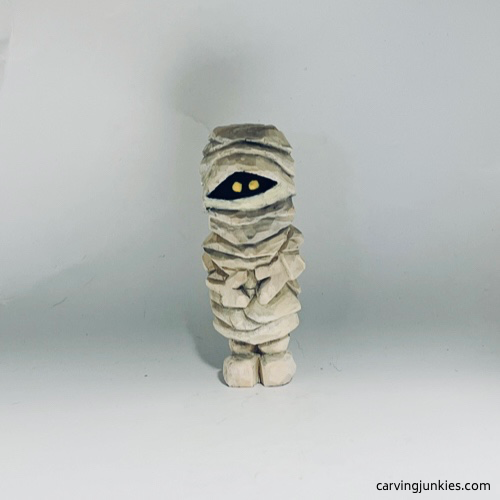 Front side on painted wood carved mummy Front view of painted wood carved mummy