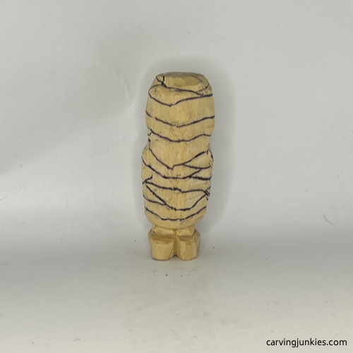 Bandages drawn on back of wood carved mummy Details drawn on back of wood carved mummy