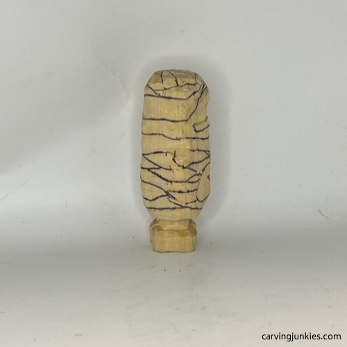 Left side of of wood carved mummy Details drawn on right side of wood carved mummy
