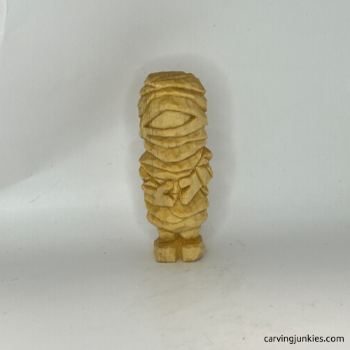 Front view on unpainted wood carved mummy Wood carved mummy before painting