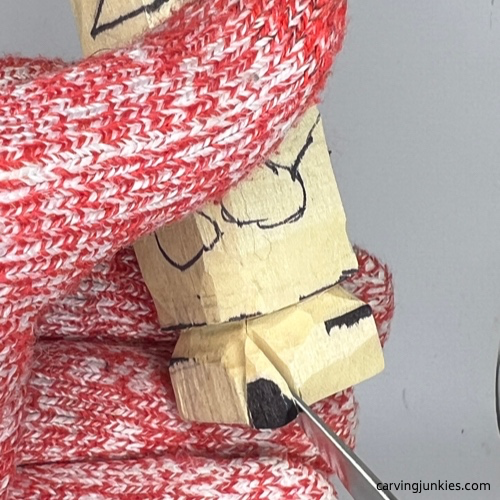 Separating legs on wood carved mummy Making a V-cut on wooden mummy carving