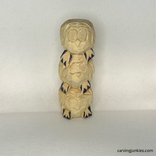 Marked wood for removal on feet of wood carved owl