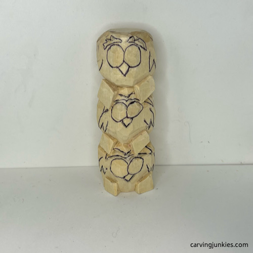 Drawn face details on wood carved owl