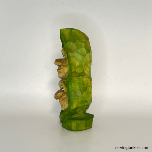 Left side of painted pea pod wood carving Left view of painted pea pod wood carving