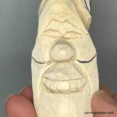 Cheeks on wood pear carving caricature are sketched