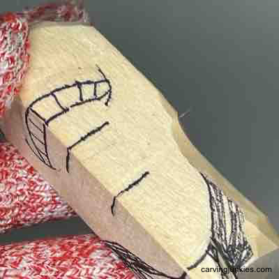 Making a stop cut on wood pear caricature carving